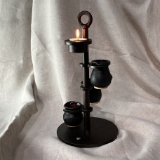 Candlestick with tea light and three Sytch Farm volcanic black jugs.