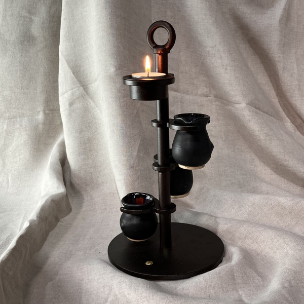 Candlestick with tea light and three Sytch Farm volcanic black jugs.